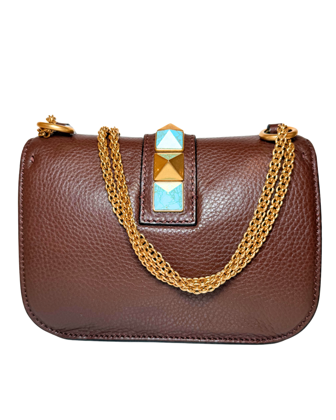 A brown pebbled leather shoulder bag with a gold chain strap featuring gold and turquoise-colored stones, shown against a plain white background.