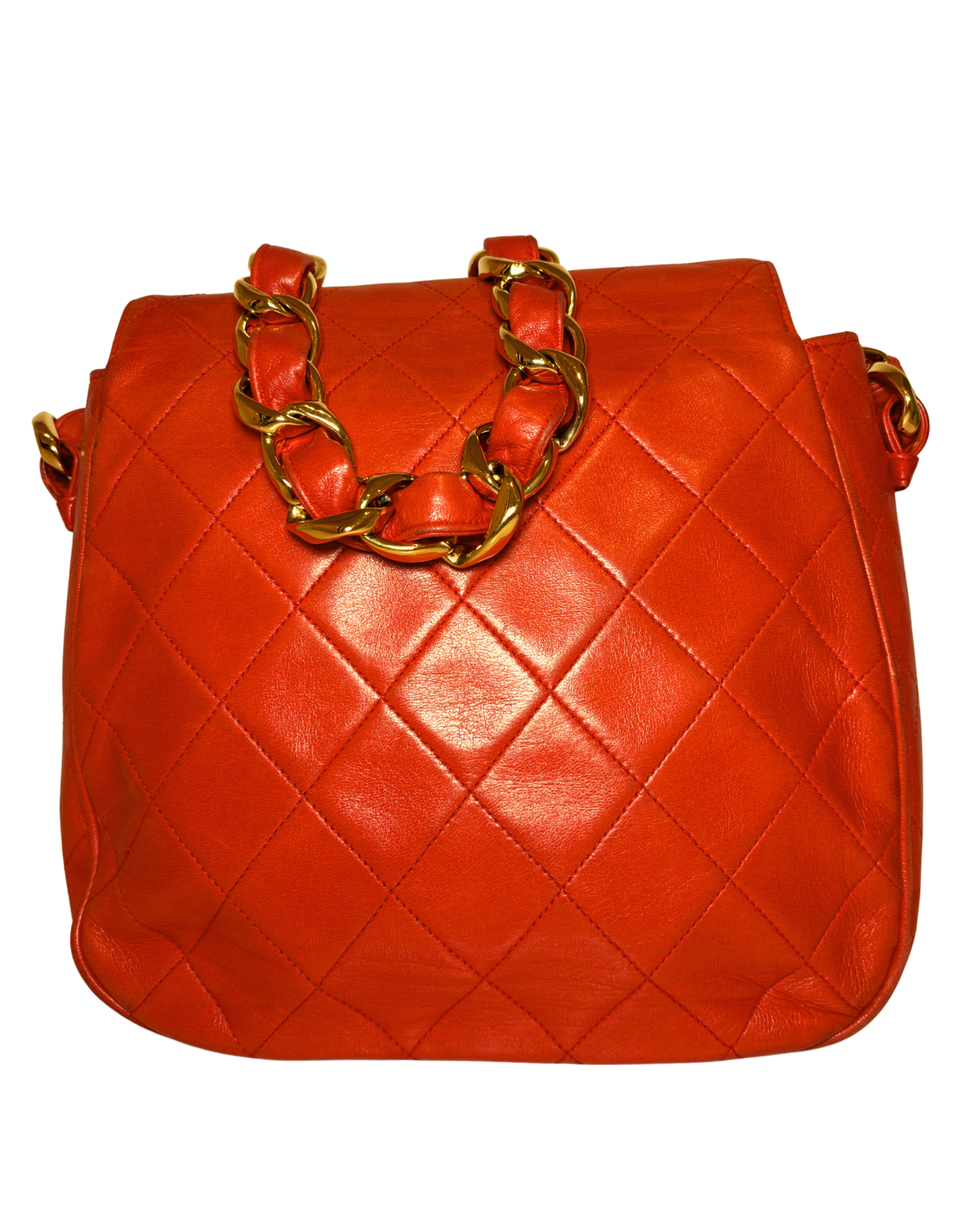 A bright orange-red quilted leather handbag with a gold-tone chain-link handle, shown against a plain white background.
